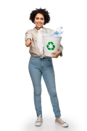 smiling young woman sorting plastic wasteの写真素材