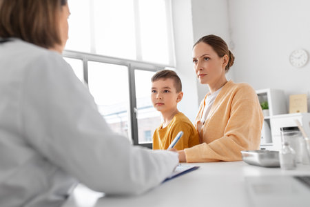 mother, son and doctor talking at clinicの写真素材