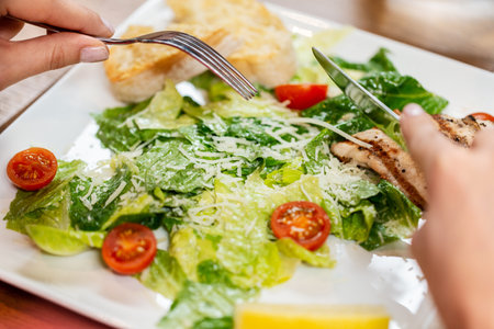 close up of woman eating at restaurantの写真素材