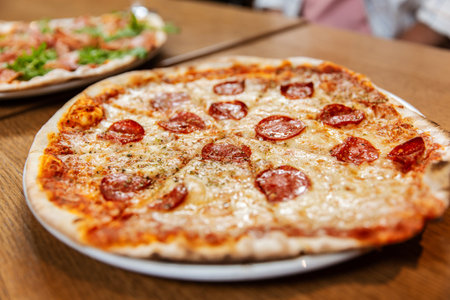 close up of pizza on wooden tableの写真素材