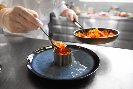 close up of chef cooking food at restaurant