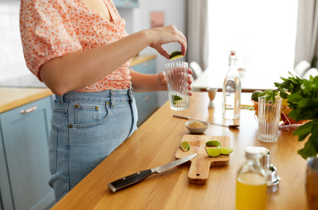 woman making cocktail drinks at home kitchenの写真素材
