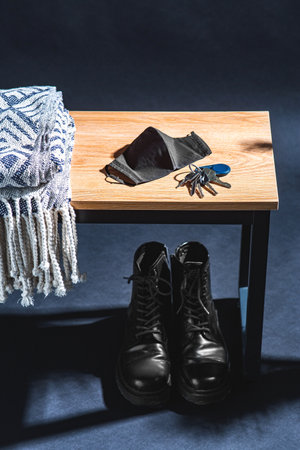 blanket, mask and keys on and boots under benchの写真素材