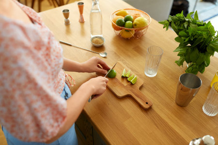 woman making cocktail drinks at home kitchenの写真素材
