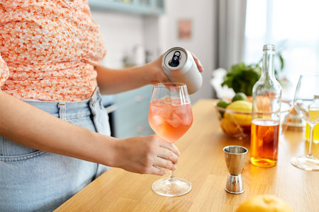 woman making cocktail drinks at home kitchenの写真素材