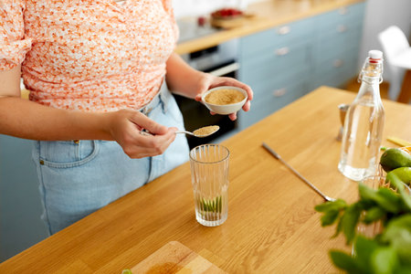 woman making cocktail drinks at home kitchenの写真素材