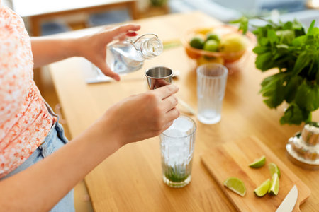 woman making cocktail drinks at home kitchenの写真素材