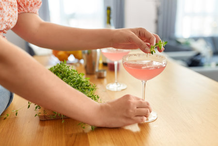 woman making cocktail drinks at home kitchenの写真素材