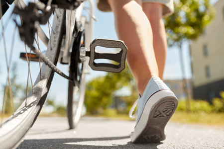 close up of woman with bicycle walking in cityの写真素材