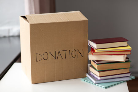 books and cardboard donation box at homeの写真素材