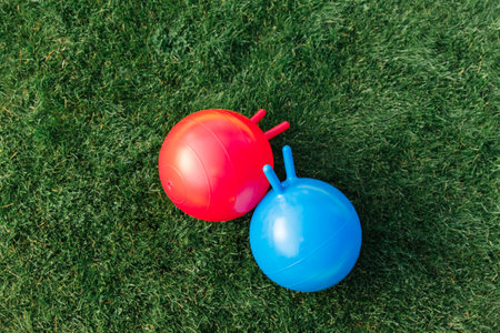 two bouncing balls or hoppers on grassの写真素材