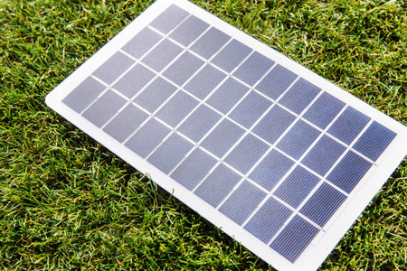 close up of solar battery model on green grass