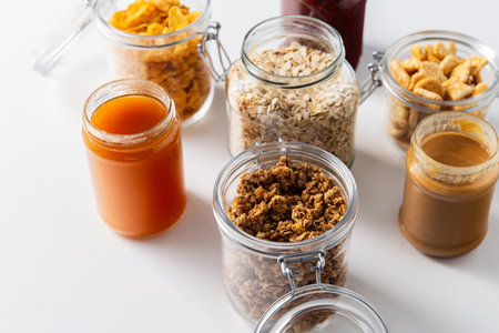 close up of jars with oat, corn flakes and granolaの写真素材