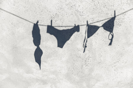 shadow of lingerie hanging on rope outdoorsの写真素材