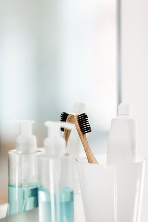 toothbrush and toothpaste on mirror in bathroom