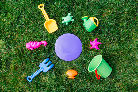 close up of sand toys kit on green lawn or grassの写真素材