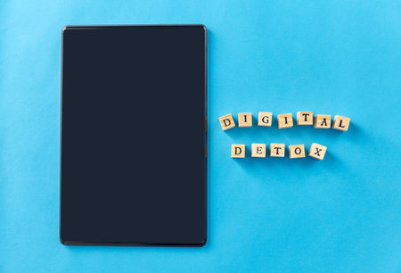 tablet pc and digital detox words on wooden blocksの写真素材
