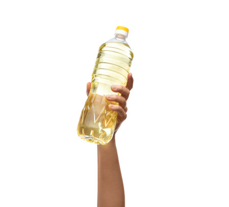 hand holding cooking oil in plastic bottleの写真素材