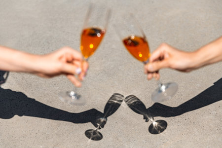 close up of hands clinking wine glassesの写真素材