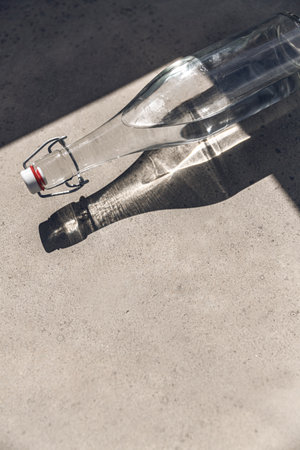 glass bottle of water on sunny floorの写真素材