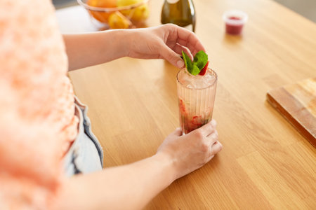 woman making cocktail drinks at home kitchenの写真素材