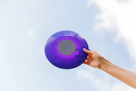 close up of hand holding flying discの写真素材