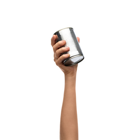 hand holding tin can with preserved foodの写真素材