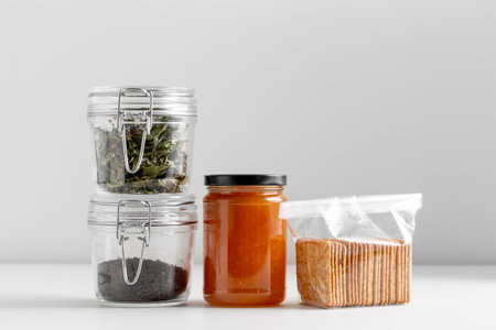 jars with dried herb, tea, jam and cookiesの写真素材