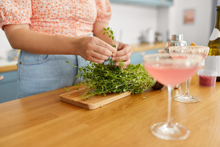 woman making cocktail drinks at home kitchenの写真素材