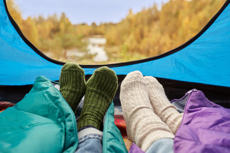 view from camp tent with feet under sleeping bagsの写真素材