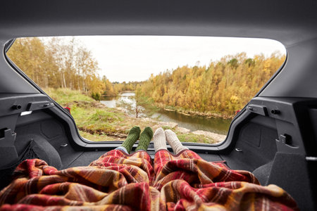 view to river from car with feet under blanketの写真素材