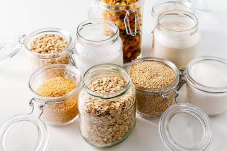 jars with cereals, pasta and beans from topの写真素材