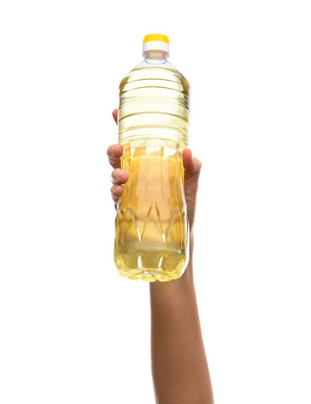 hand holding cooking oil in plastic bottleの写真素材