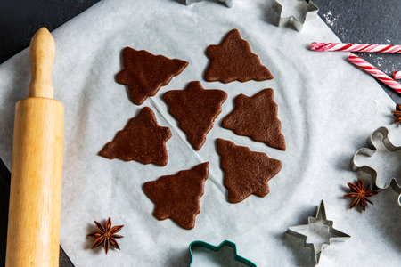 gingerbread dough, molds and rolling pin on tableの写真素材
