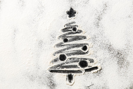 christmas tree drawing on powdered sugarの写真素材