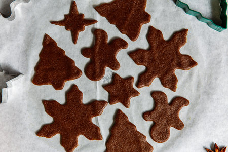 gingerbread dough, molds and rolling pin on tableの写真素材
