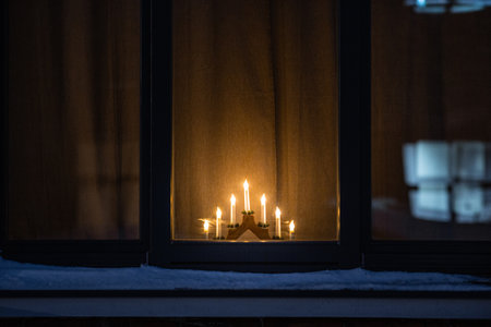 advent candlestick on window sill at nightの写真素材