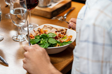 close up of man eating at restaurant