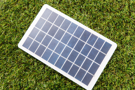 close up of solar battery model on green grassの写真素材