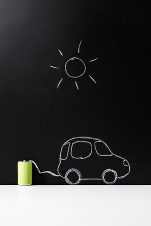 electric car charging from battery over blackの写真素材