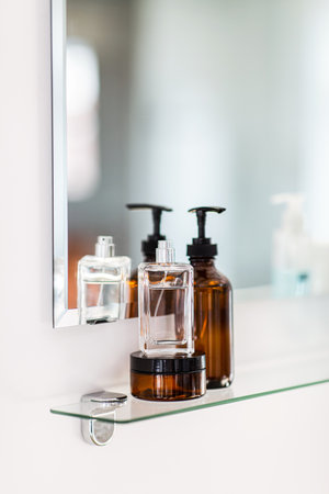 lotion, perfume and moisturizer on bathroom mirrorの写真素材