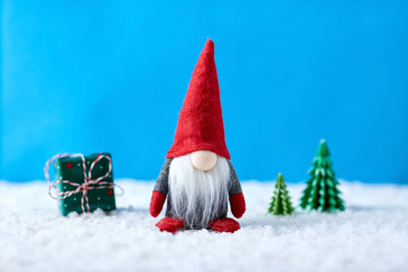 close up of gnome and christmas trees on snowの写真素材