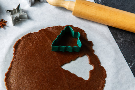 gingerbread dough, molds and rolling pin on tableの写真素材