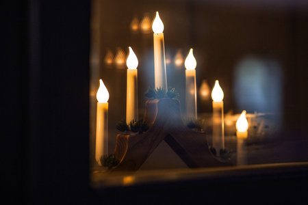 advent candlestick on window sill at nightの写真素材