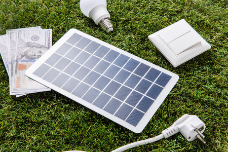 solar battery, bulb, money, bills and calculator