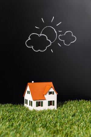 close up of house model on grass over blackの写真素材