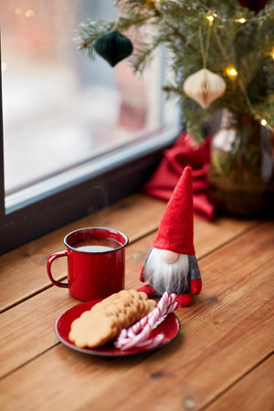 christmas gnome, coffee and cookies on window sillの写真素材