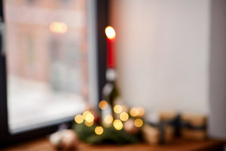 christmas wreath with candle burning on bottleの写真素材