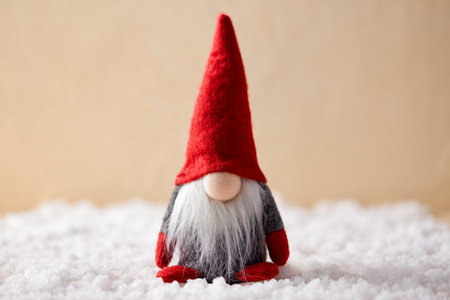 close up of christmas gnome toy on artificial snowの写真素材