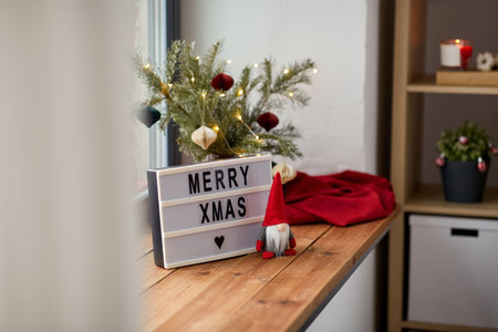 merry christmas on light box and gnome on windowの写真素材